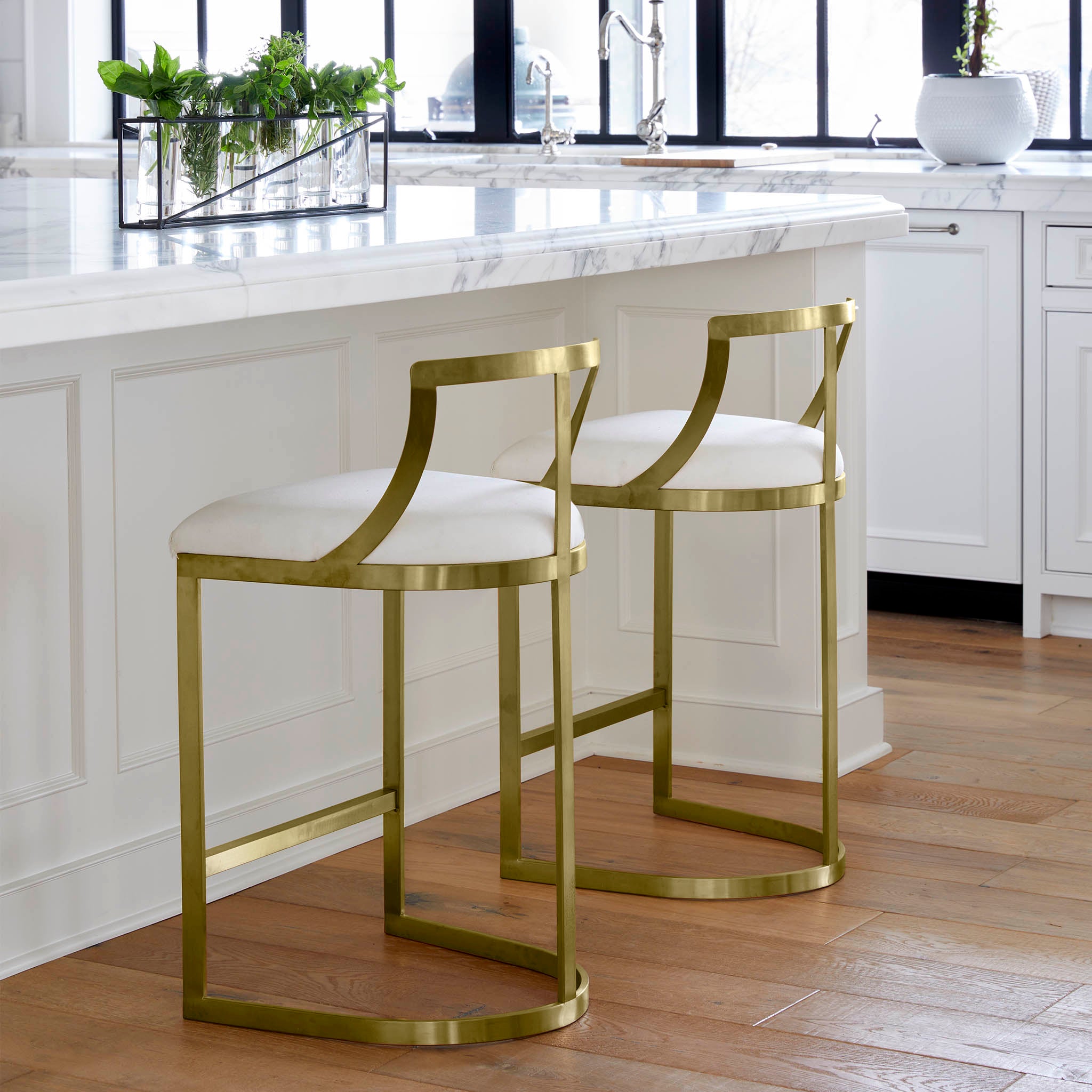 Emerson Stool – Pair of stools at kitchen island, gold and white finish.