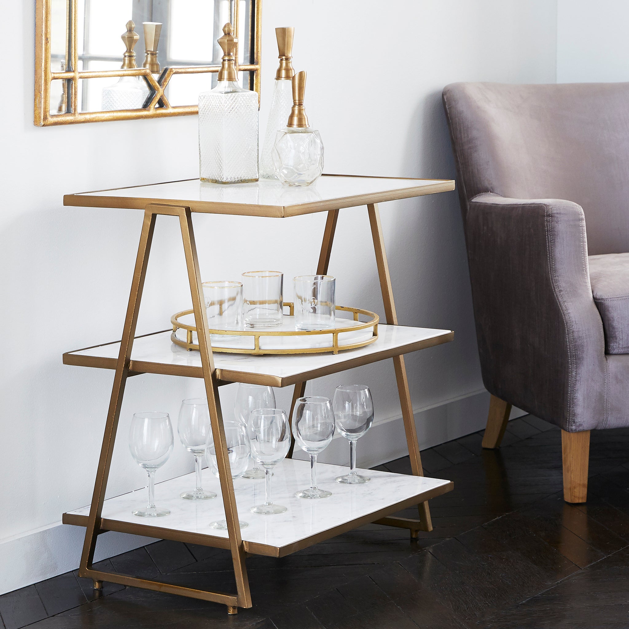 Three Tier Marble Top Table - Angled side view, styled with glassware.
