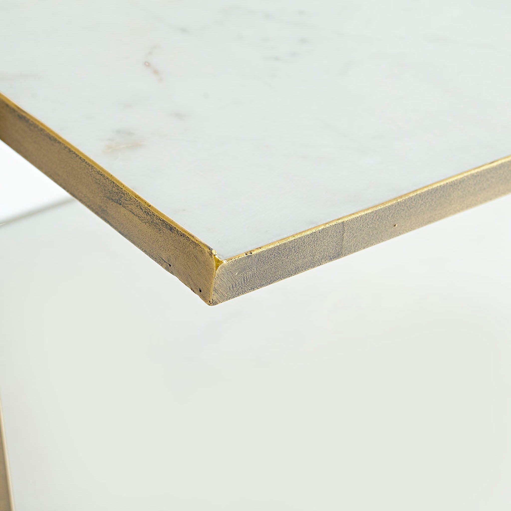 Three Tier Marble Top Table - close-up, white background, corner detail.