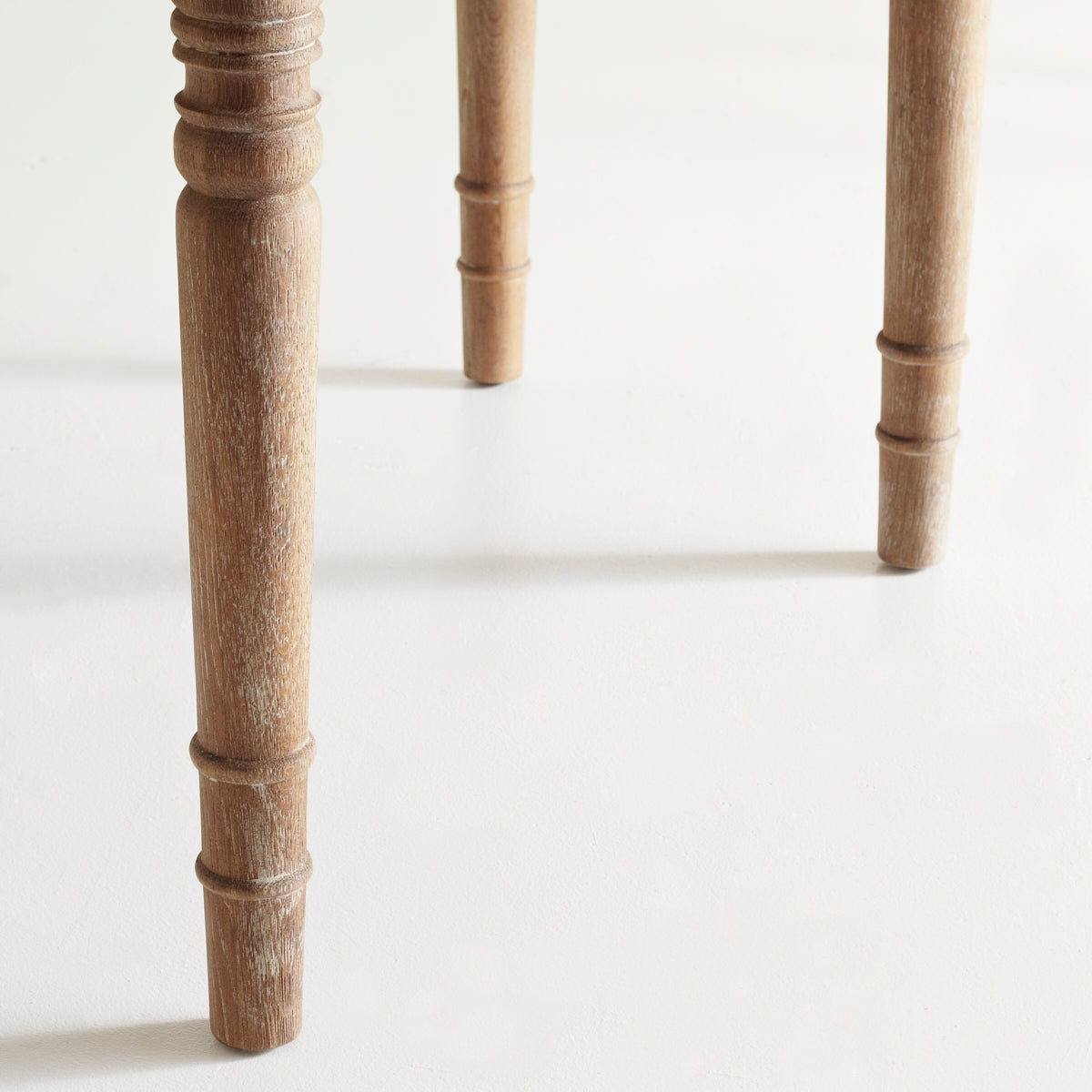 Close-up of a table leg, turned wood design, natural finish.Expandable Oak Farmhouse Table –