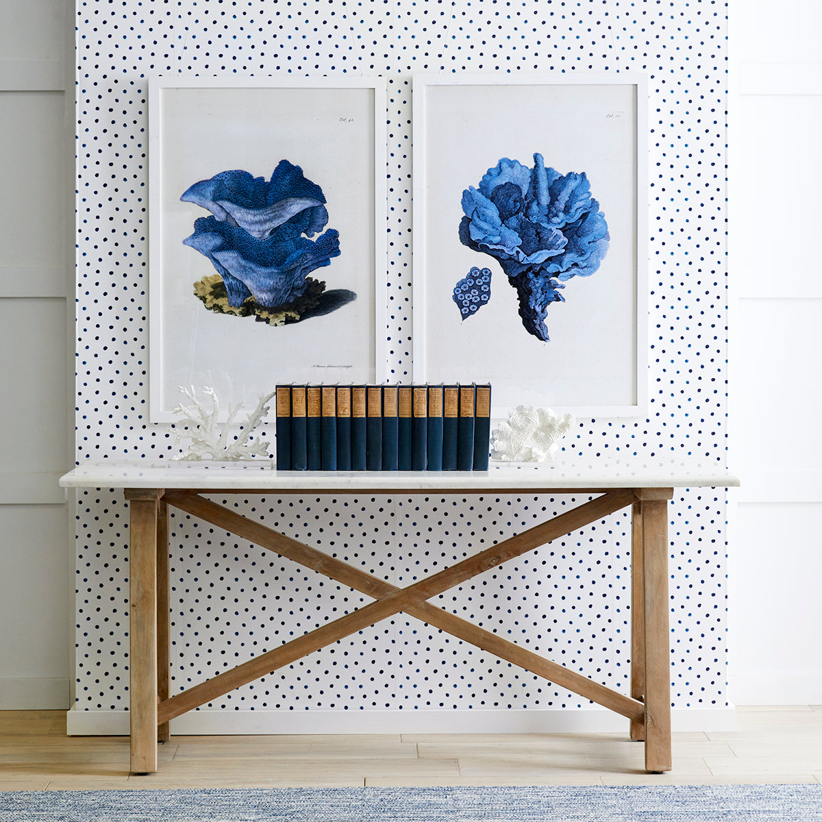 Marble Top Console Table – Styled against polka dot wallpaper, books, blue artwork above.