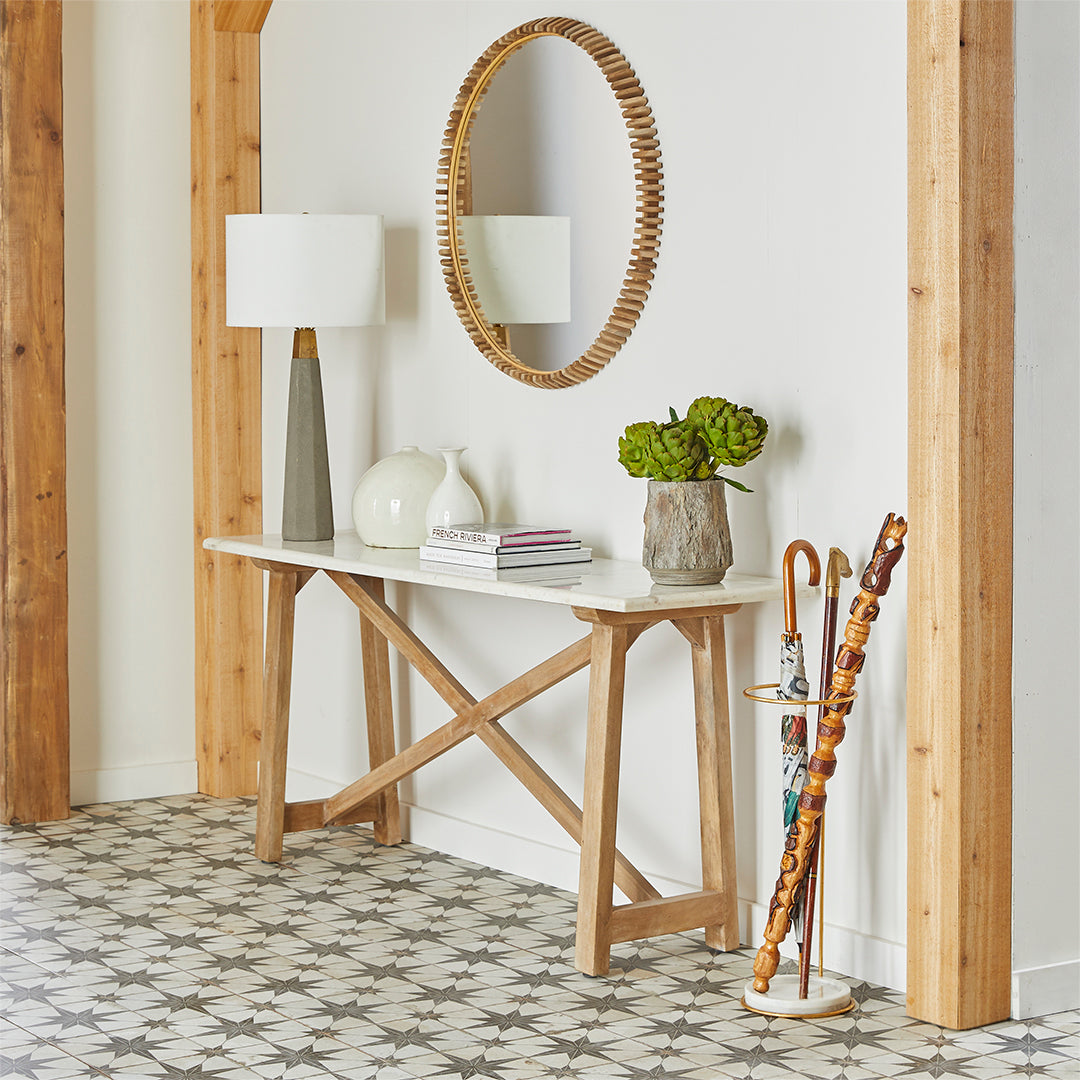 Marble Top Console Table – Entryway setup, round mirror above, decorative vases, books, umbrella stand.