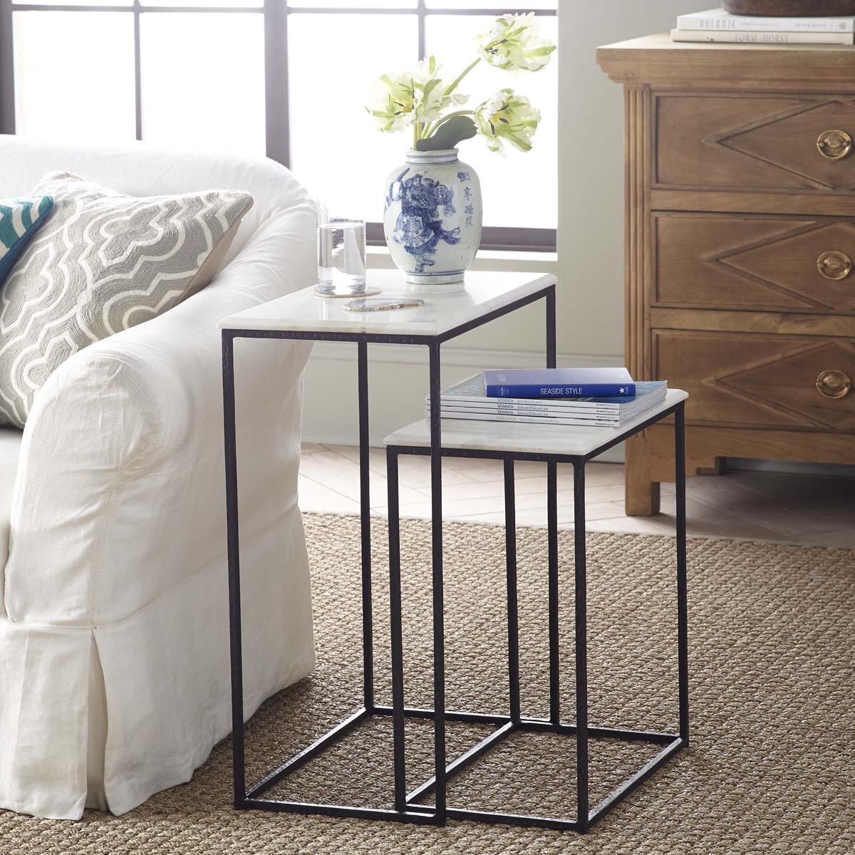 Marble Nesting Side Tables – Styled with books, vase, and glass in a cozy setting.