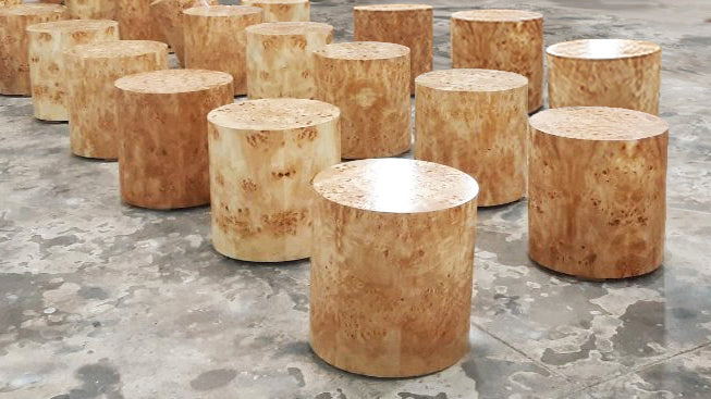 Multiple Cylinder Burl Wood Side Tables On Marble Floor