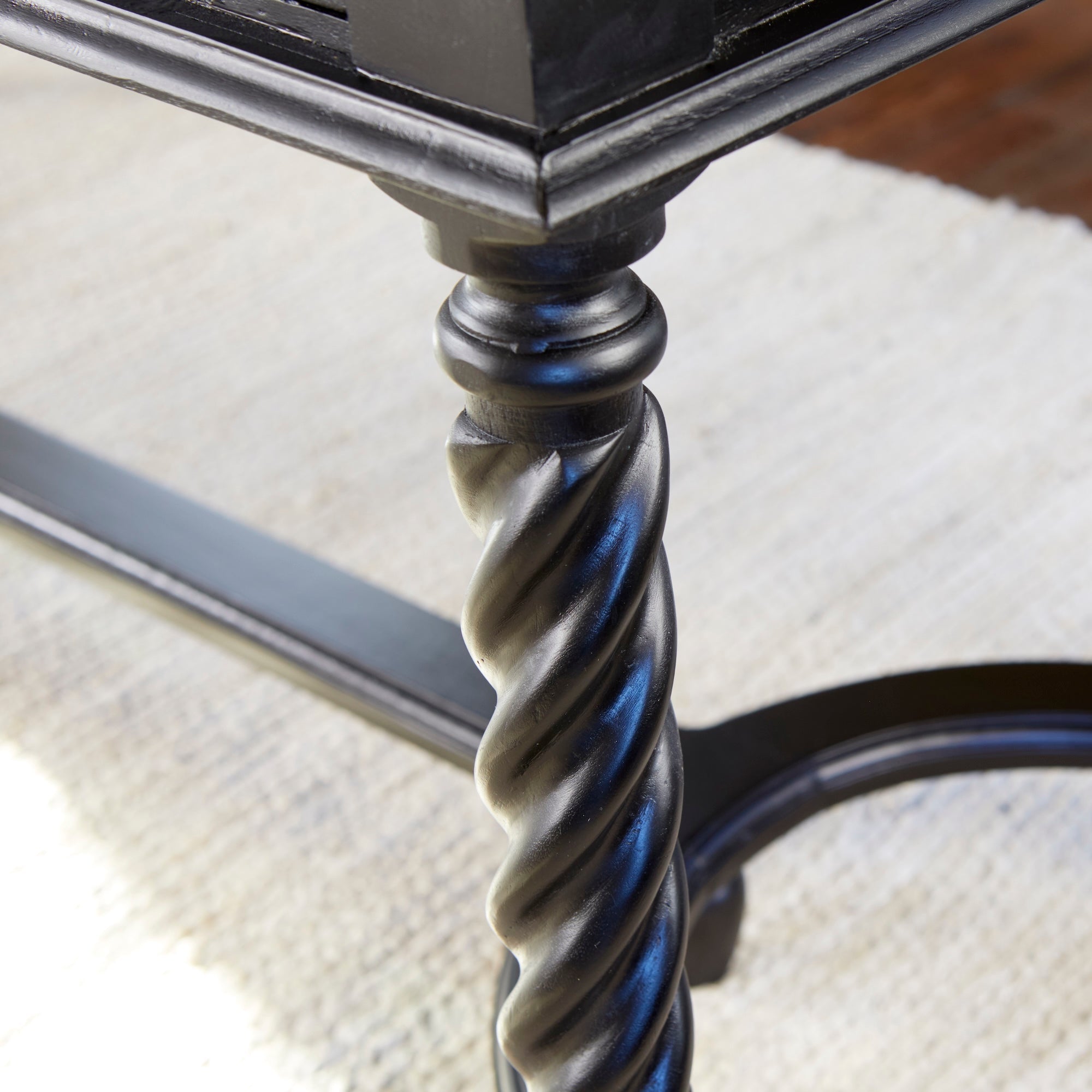 Barley Twist Desk – Black – close-up of spiral leg on rug.