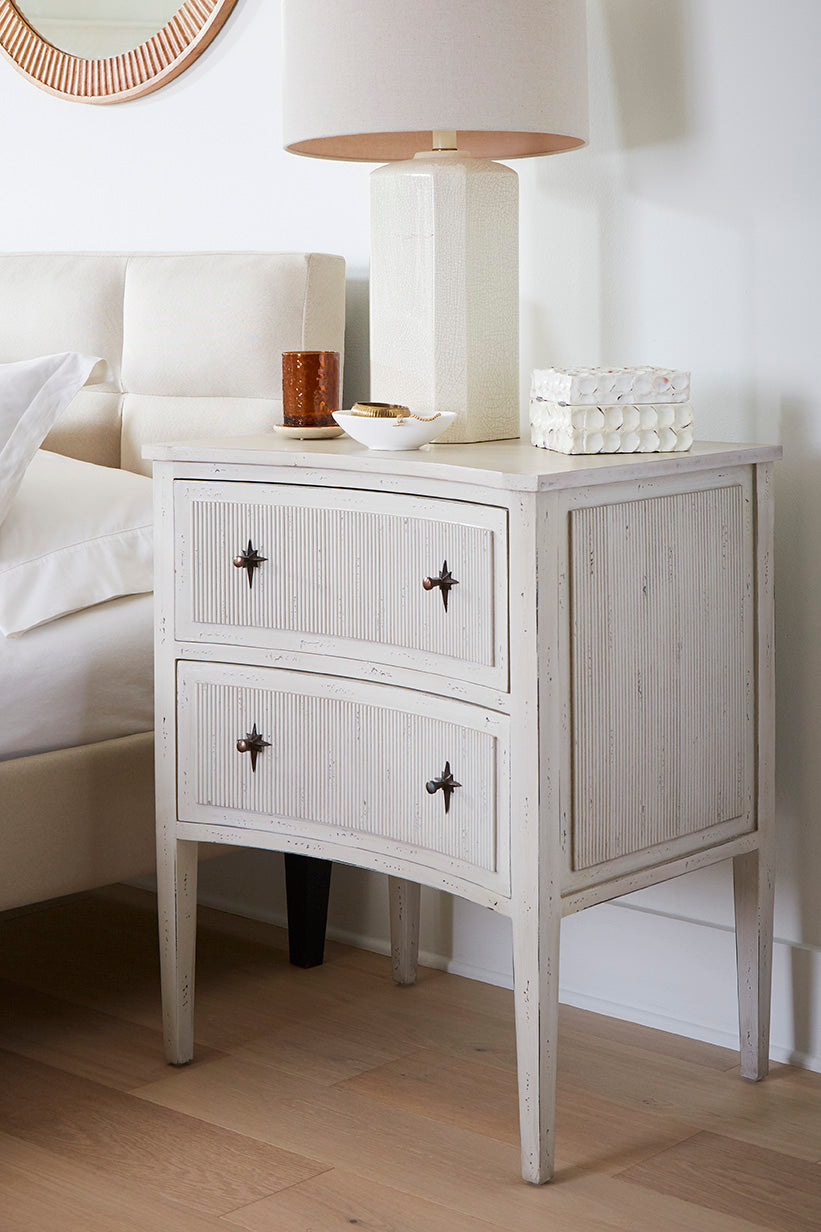 Ivory Starlight Chest in a Bedroom Setting with a Lamp on Top