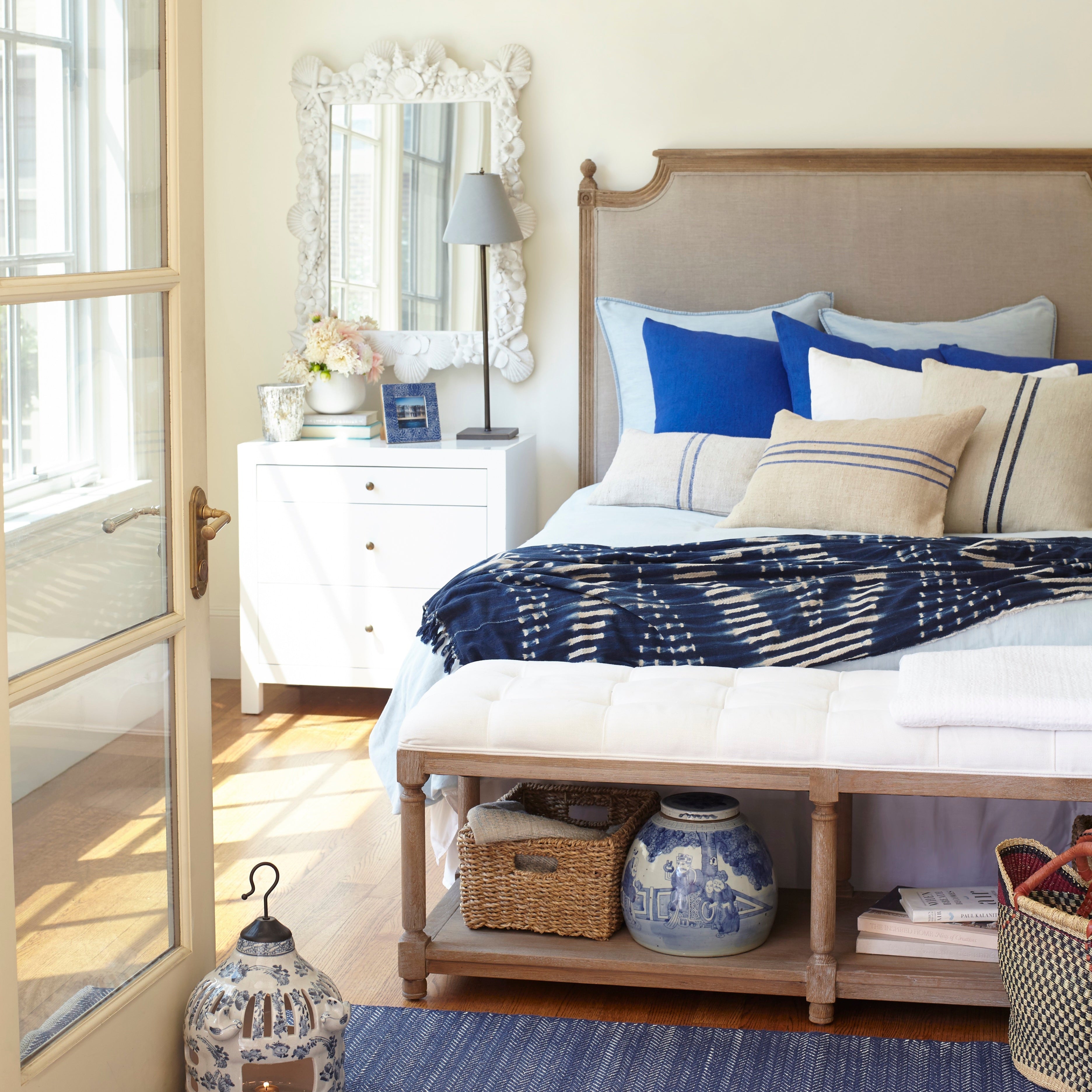 Small Sleek Chest - White chest styled beside bed in bright room.