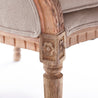 Close-up of the ornate details on a natural linen Louis XV Wing Chair
