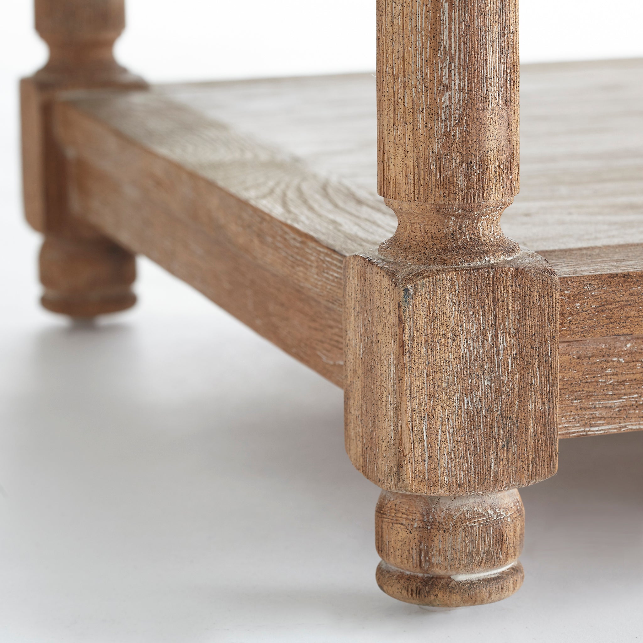 Chesterfield Bench – close-up of natural wood leg and base detail, white background.