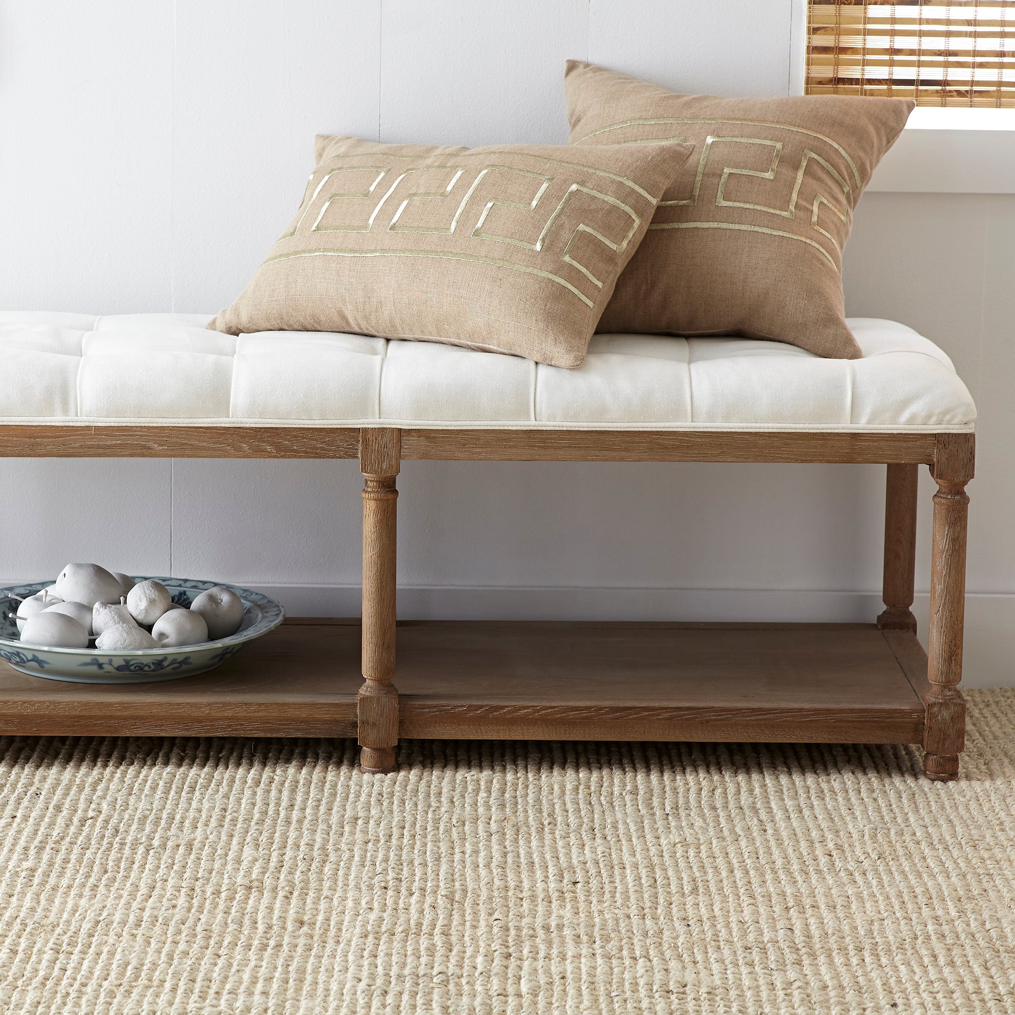 Chesterfield Bench – White cushion, natural wood, styled with tan pillows in bright living space.