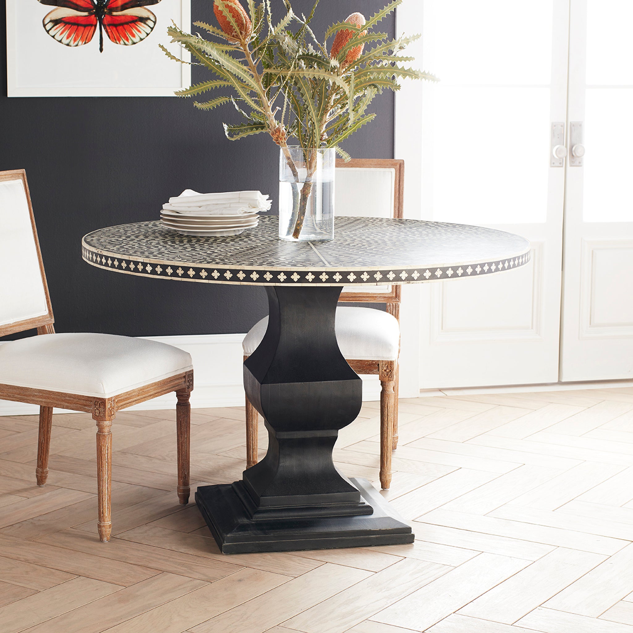 Moorish Dining Table in a Dining Room Setting With Flower Vase and Plates on Top