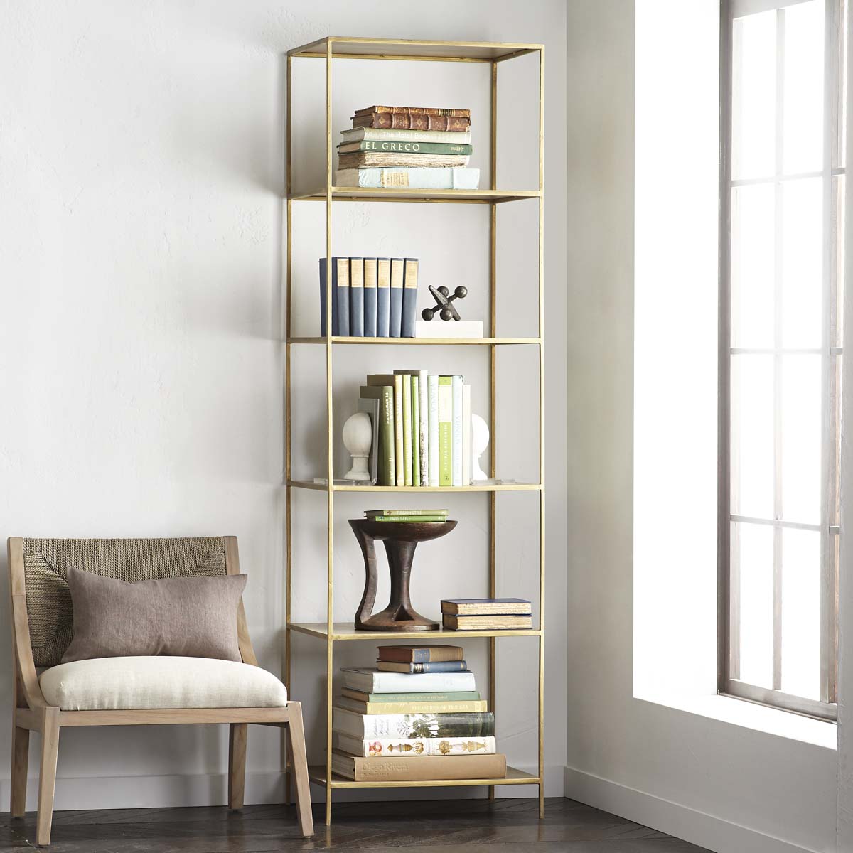 Tower Bookshelf positioned beside a chair in a room