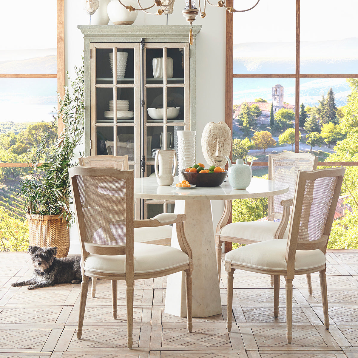 Faceted Marble Table in a room setting with a bowl of fruits on top