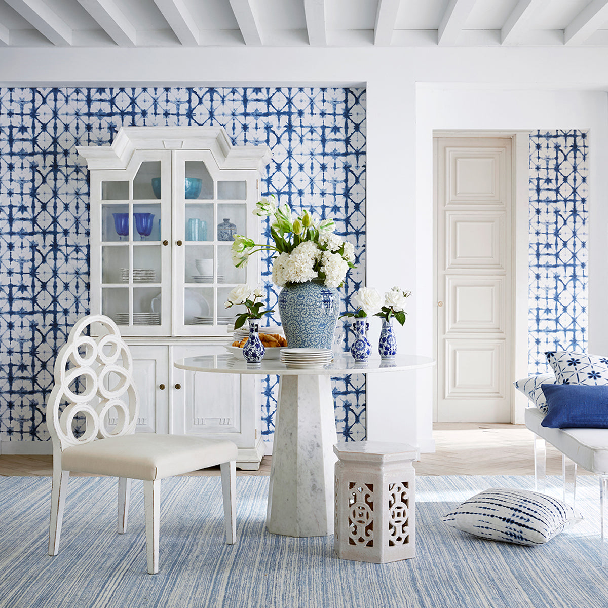 Faceted Marble Table in a room setting with a ceramic vase on top