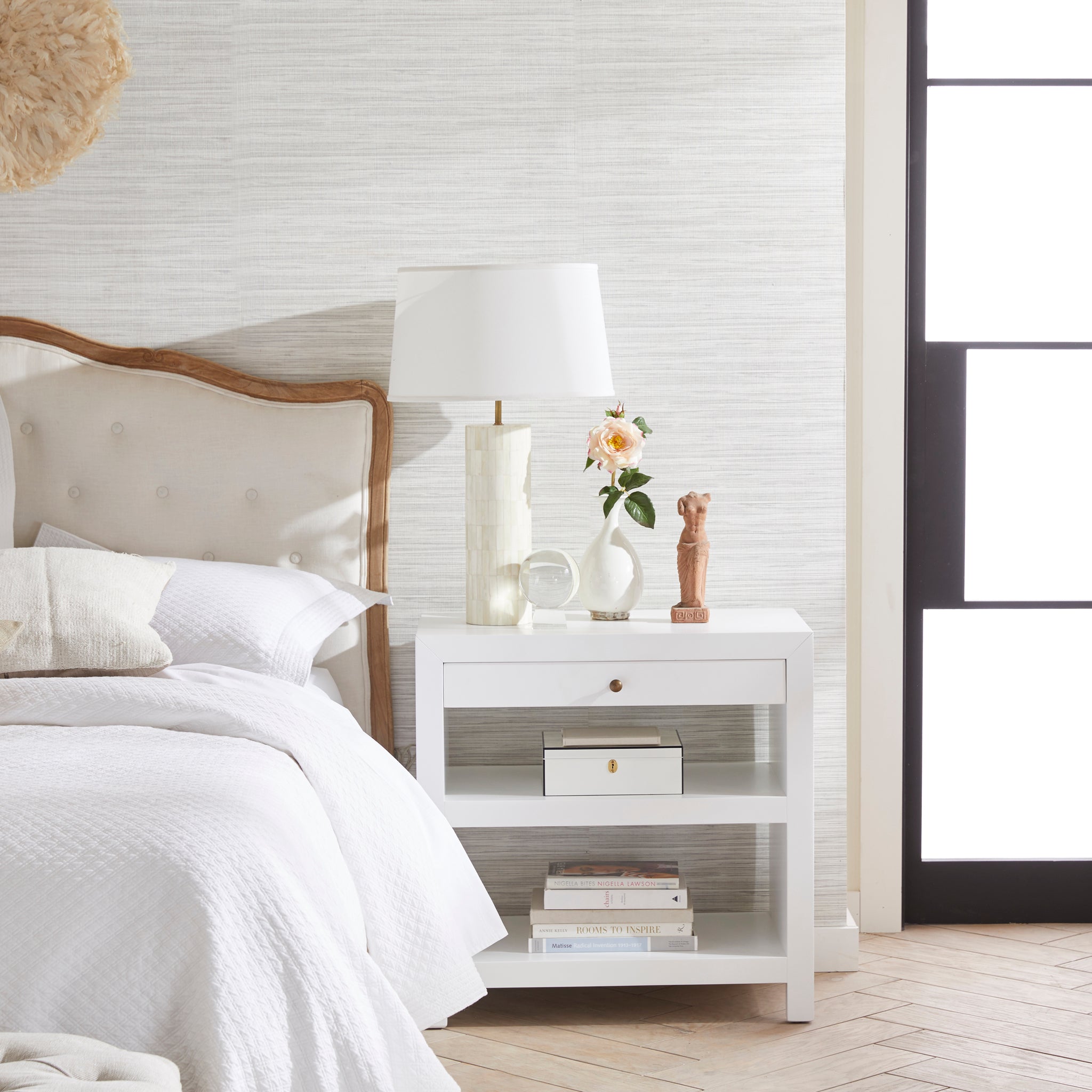 Sleek Side Table Next To Bed With Items Placed On It